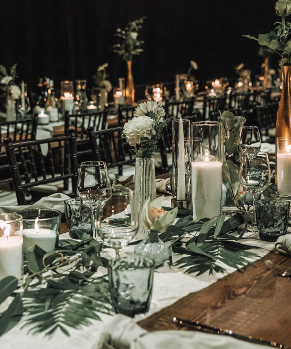 Long banquet table styled with candle sand candles