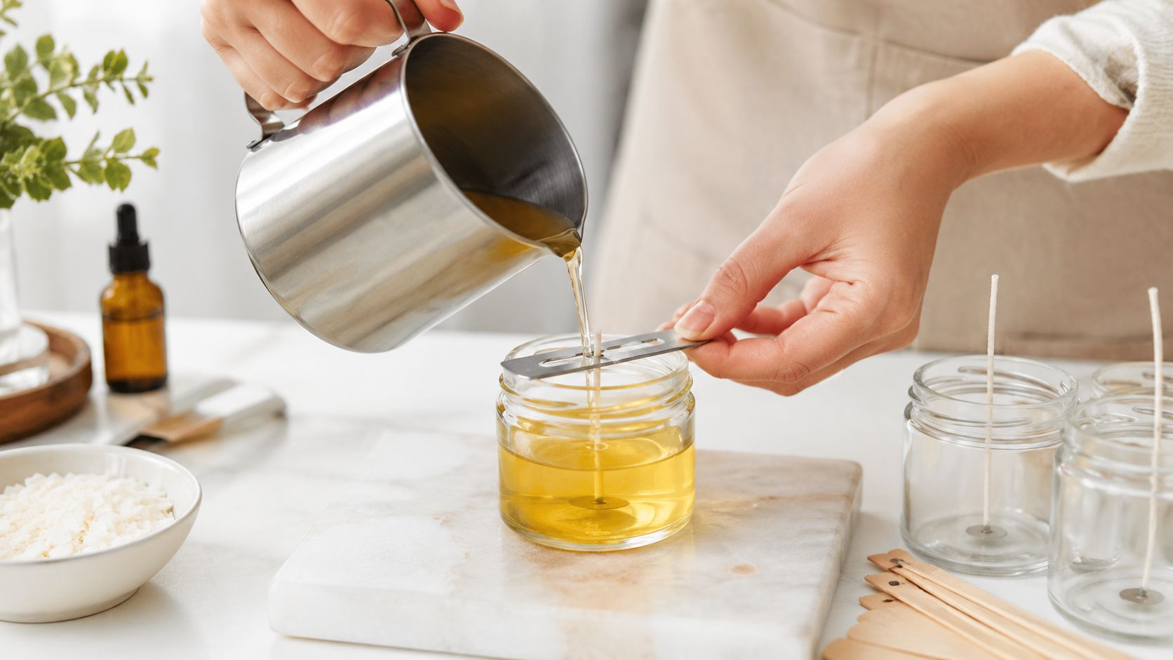 A person pouring melted wax into a glass jar to create a handmade scented candle at home.