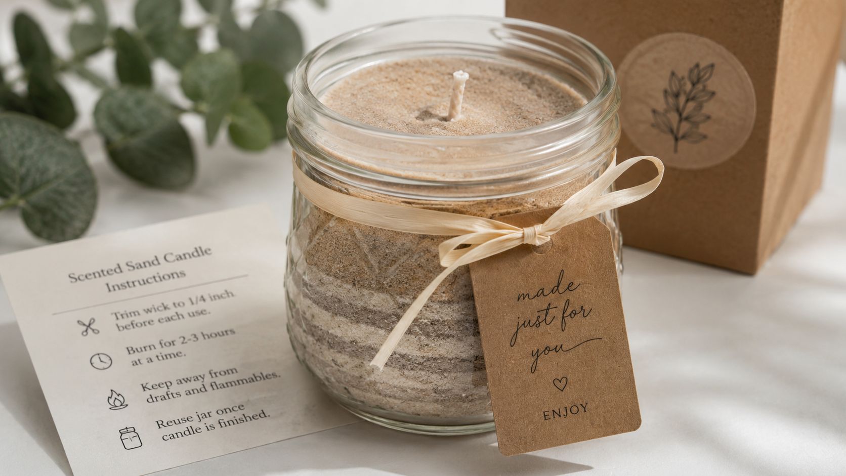A natural scented sand candle in a glass jar with instructions and a gift tag.